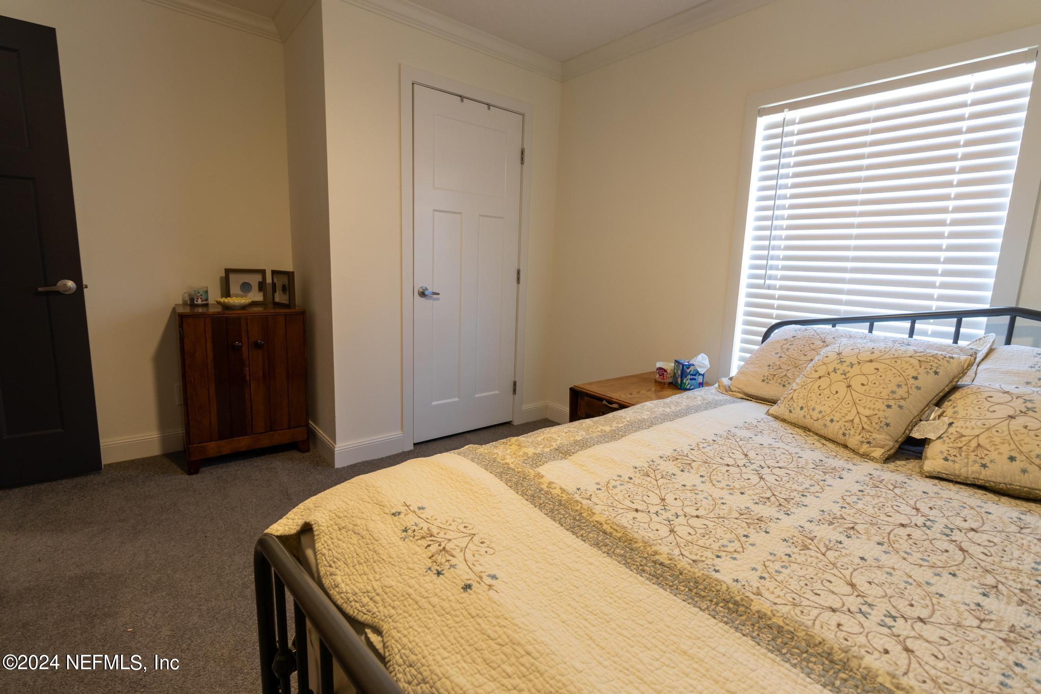 121 Honeysuckle Trail Hawthorne, FL 32640 - Photo 19 of 44 a bedroom with a bed and a walk in closet