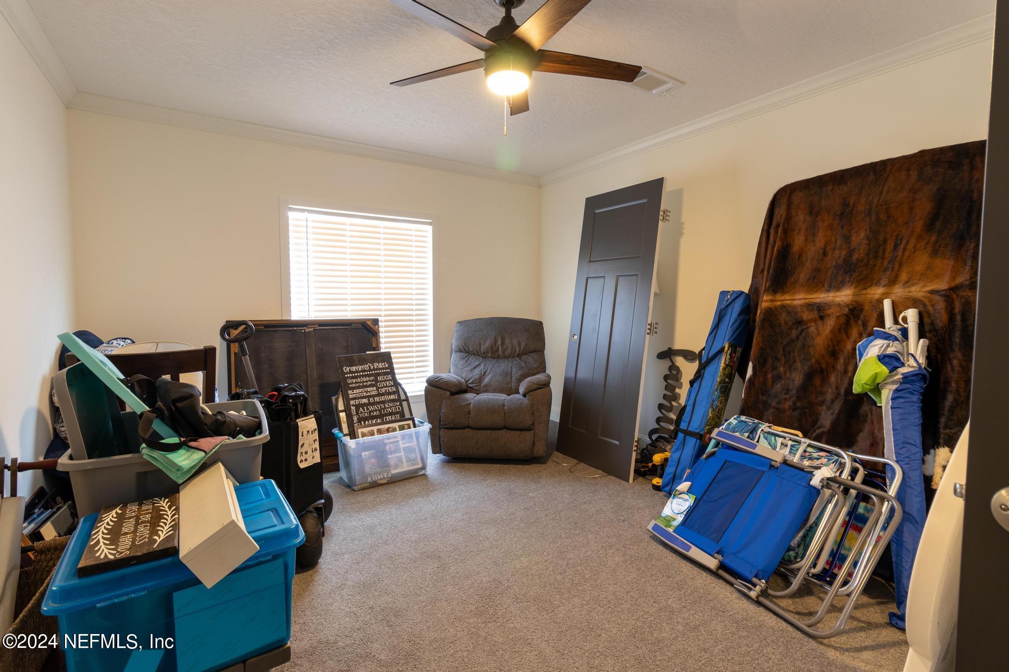 121 Honeysuckle Trail Hawthorne, FL 32640 - Photo 20 of 44 a bedroom with furniture and a gym equipment