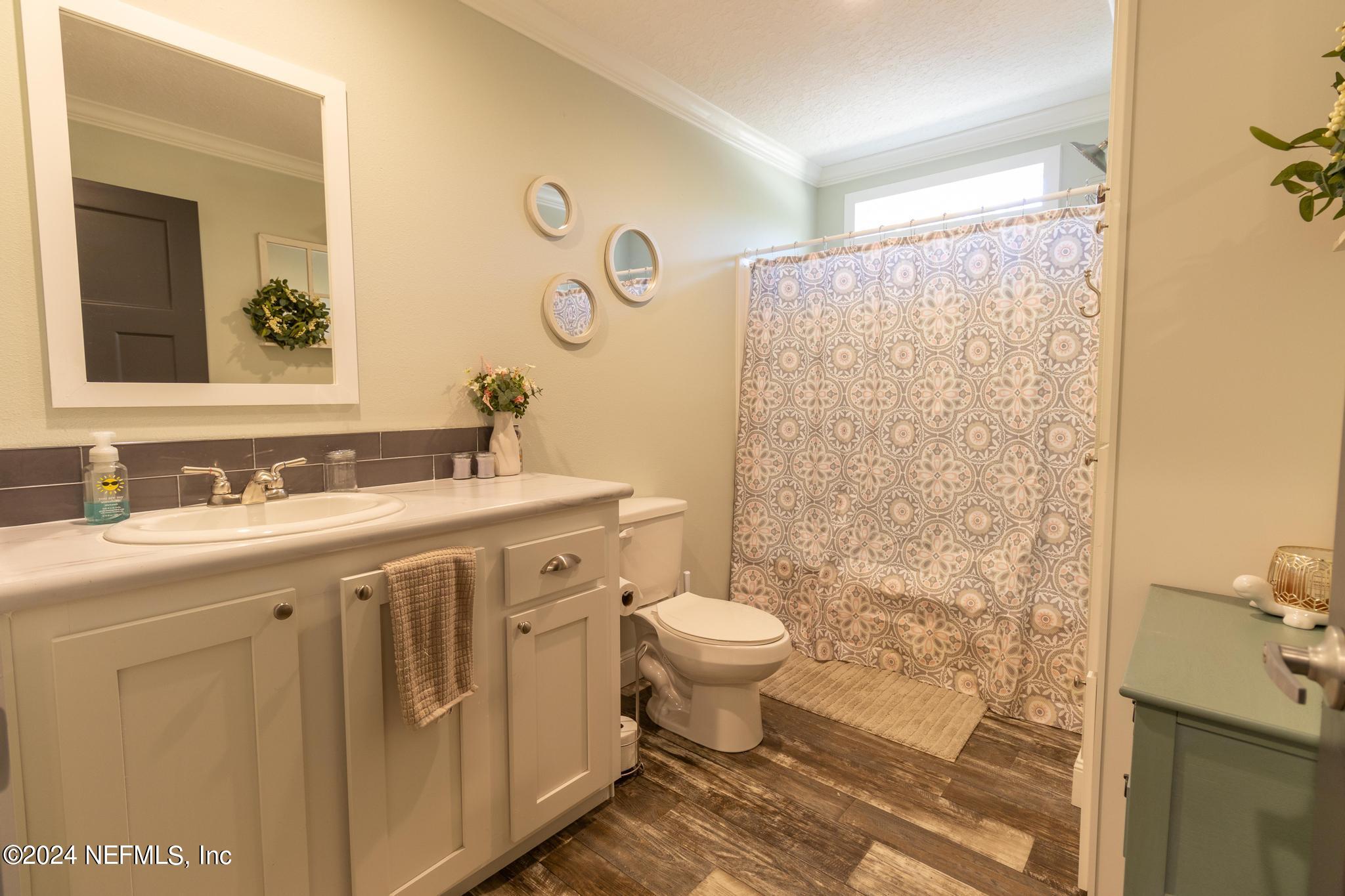 121 Honeysuckle Trail Hawthorne, FL 32640 - Photo 25 of 44 a bathroom with a sink toilet and shower
