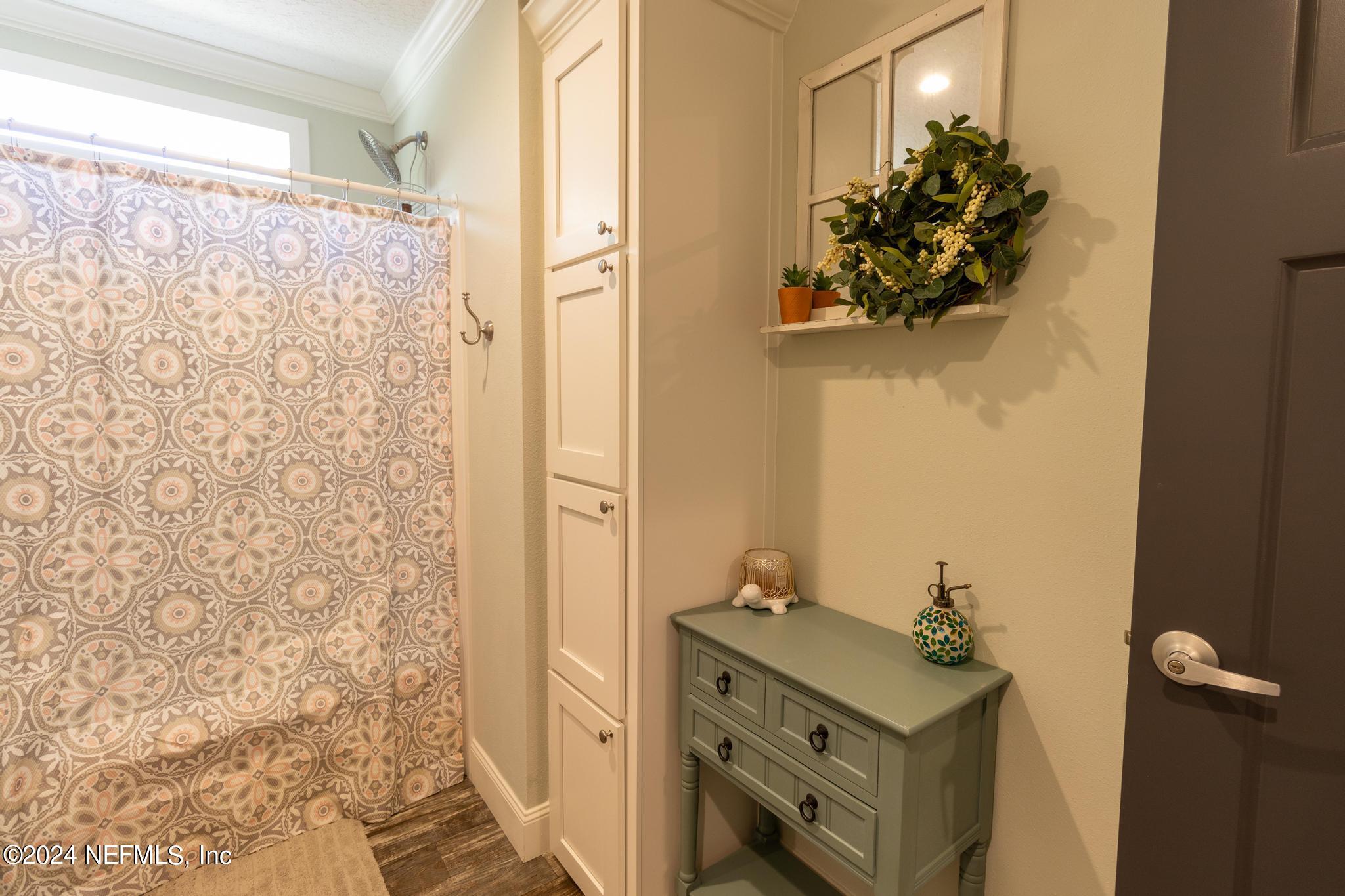 121 Honeysuckle Trail Hawthorne, FL 32640 - Photo 26 of 44 a bathroom with a sink and mirror with shower