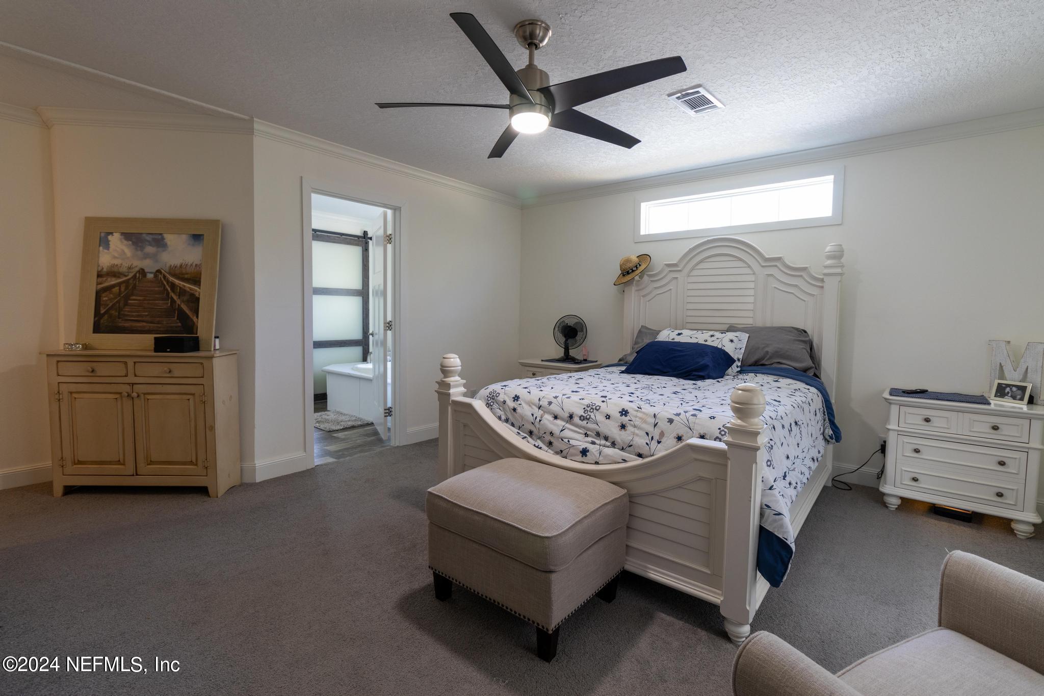 121 Honeysuckle Trail Hawthorne, FL 32640 - Photo 29 of 44 a bedroom with a bed a dresser and flowerpot