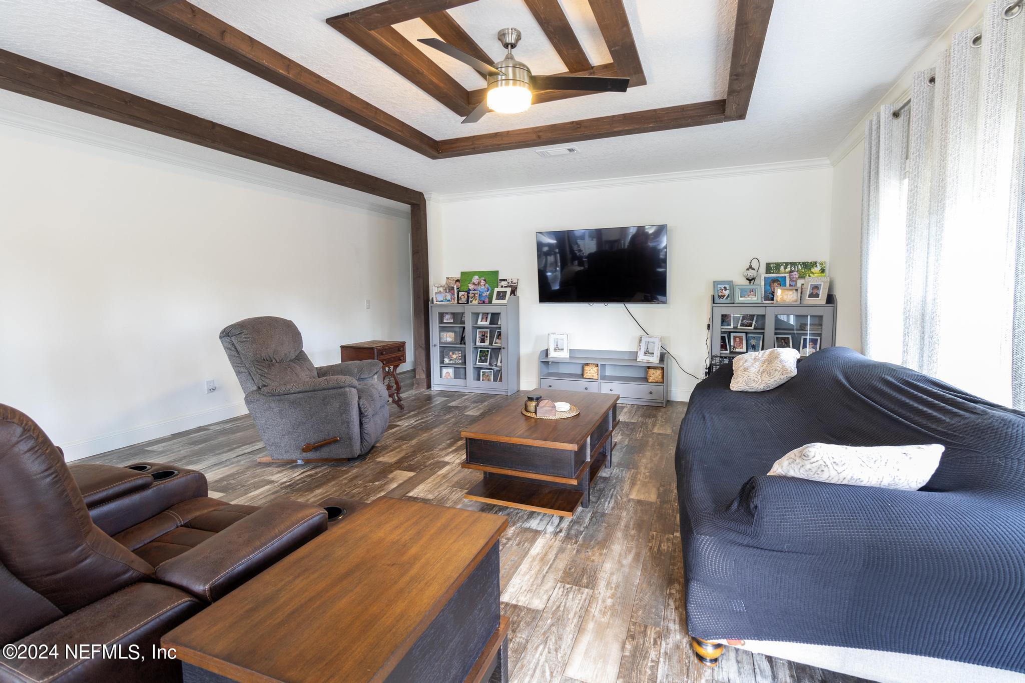 121 Honeysuckle Trail Hawthorne, FL 32640 - Photo 3 of 44 a living room with furniture and a flat screen tv