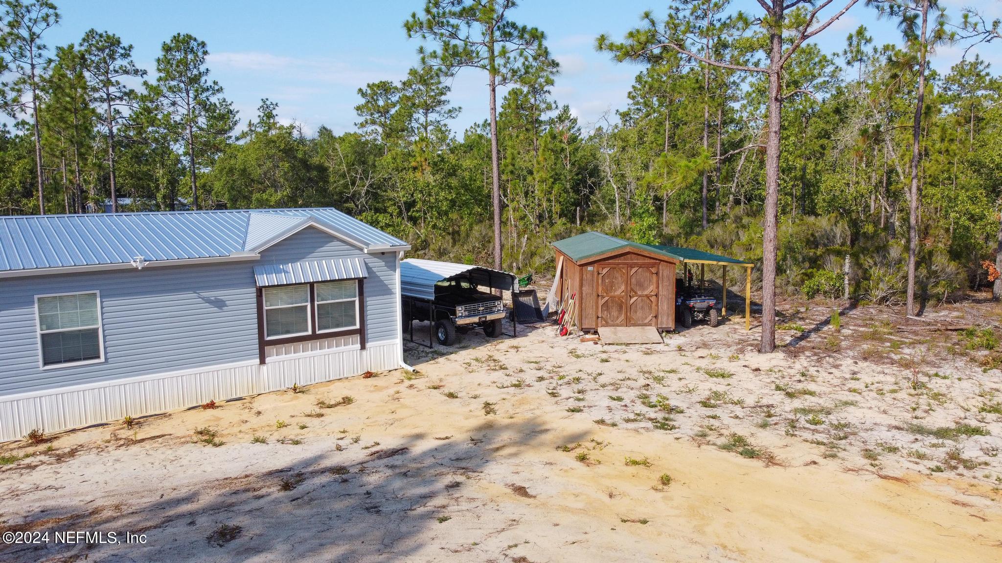 121 Honeysuckle Trail Hawthorne, FL 32640 - Photo 36 of 44 a view of a house with snow on the road