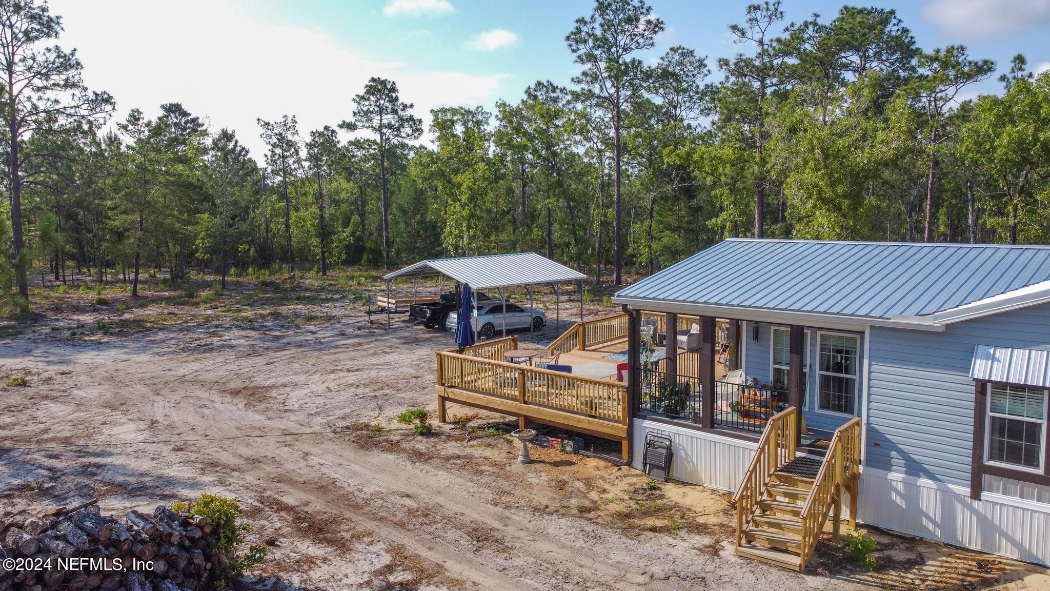 121 Honeysuckle Trail Hawthorne, FL 32640 - Photo 37 of 44 a view of a house with a yard and furniture