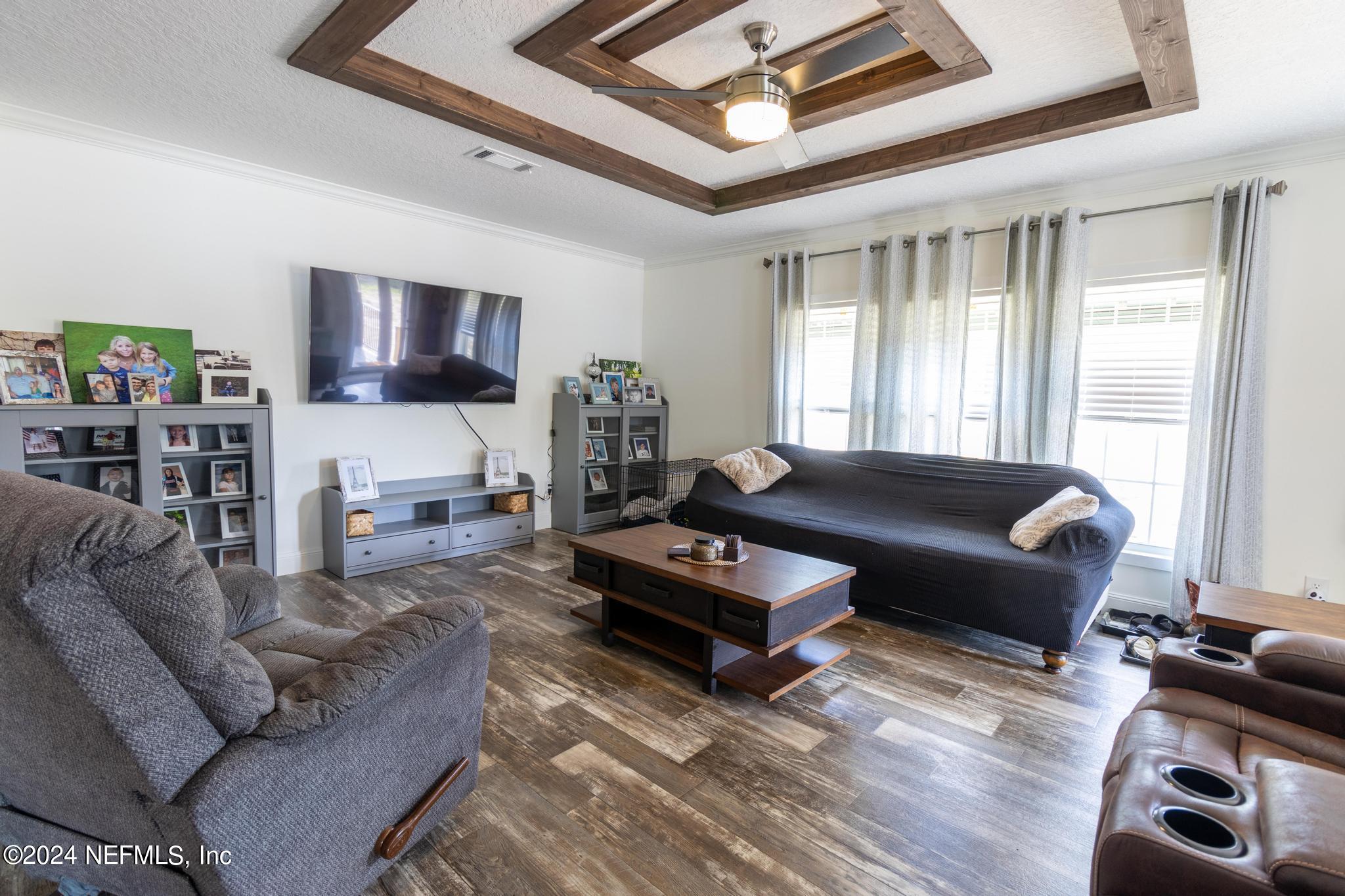121 Honeysuckle Trail Hawthorne, FL 32640 - Photo 4 of 44 a living room with furniture a flat screen tv and a window
