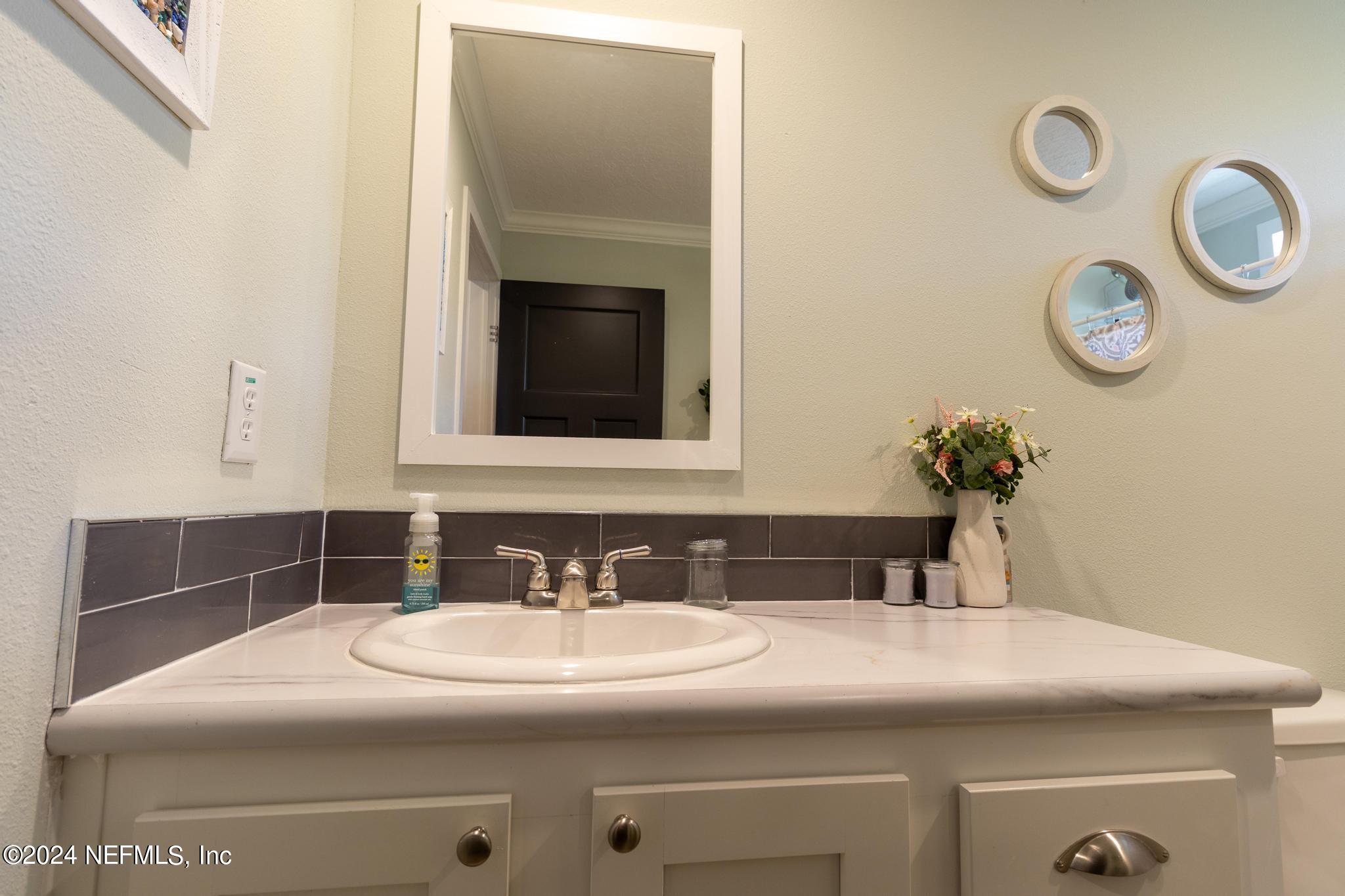 121 Honeysuckle Trail Hawthorne, FL 32640 - Photo 44 of 44 a bathroom with a sink and a mirror