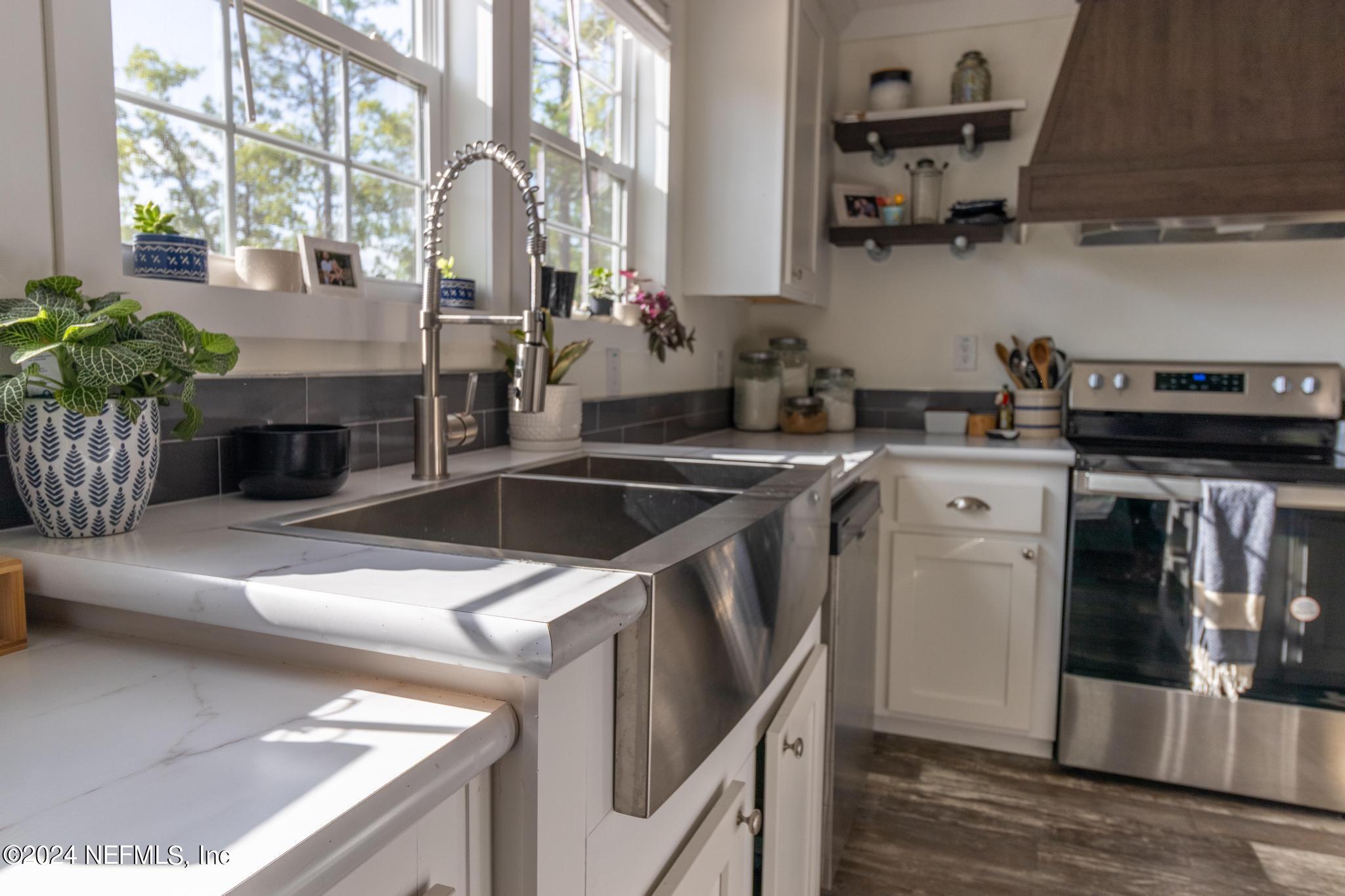 121 Honeysuckle Trail Hawthorne, FL 32640 - Photo 6 of 44 a kitchen with stainless steel appliances granite countertop a sink stove and refrigerator