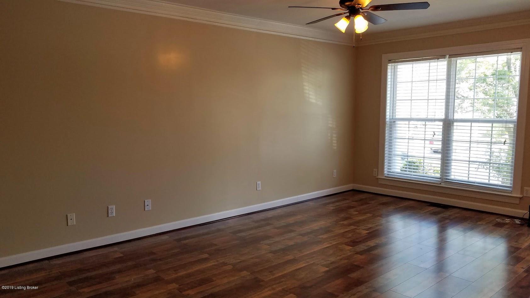 9515 Rustling Tree Way, Unit 102 Louisville, KY 40291 - Photo 6 of 27 Great Room with Crown Molding and updated laminate flooring