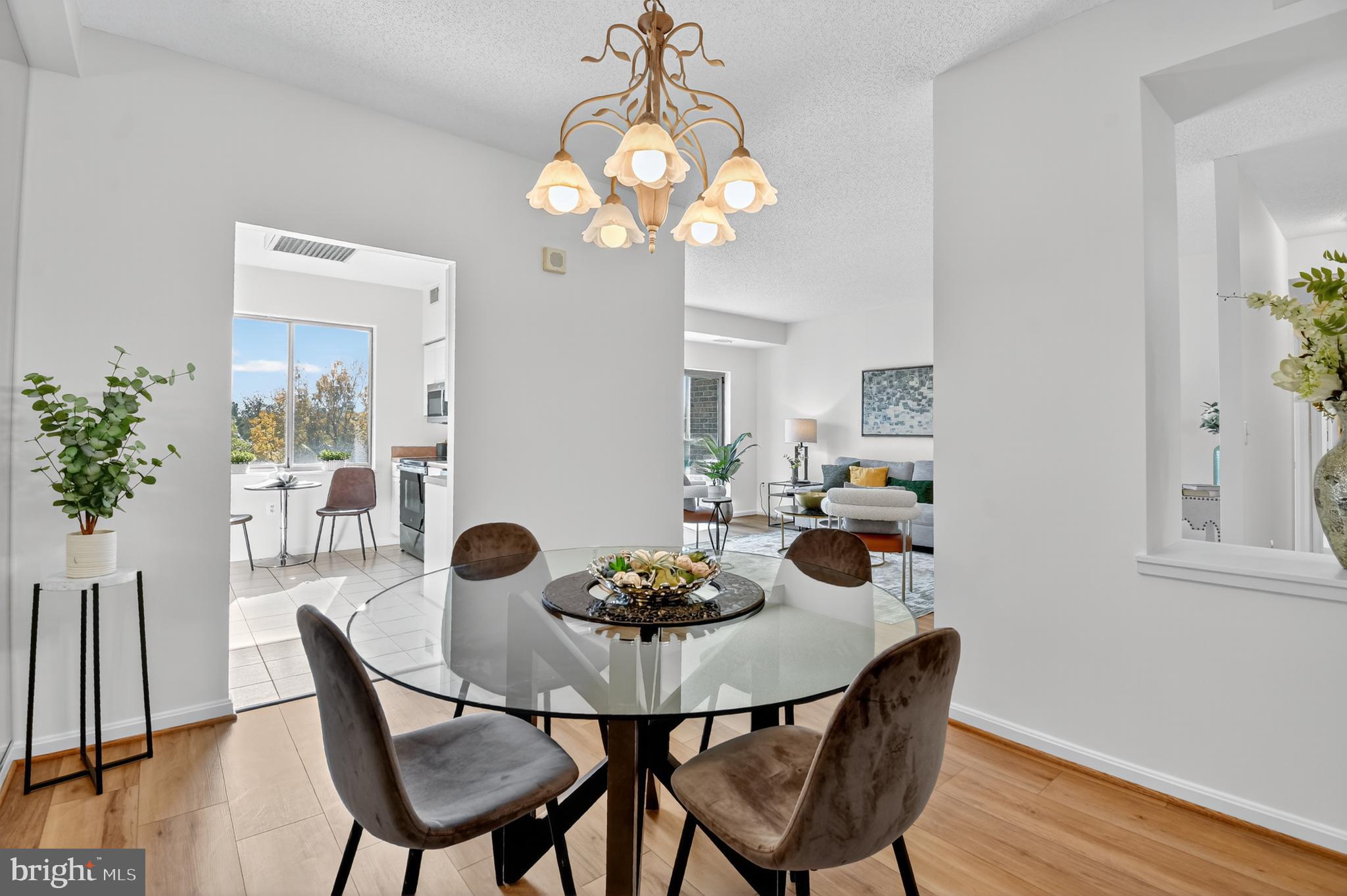 3005 South Leisure World Boulevard, Unit 426 Silver Spring, MD 20906 - Photo 12 of 45 a view of a dining room with furniture and wooden floor