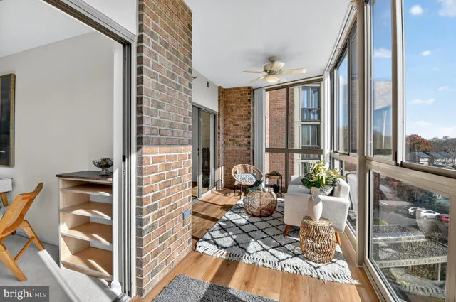 a view of a balcony with chairs and floor to ceiling window