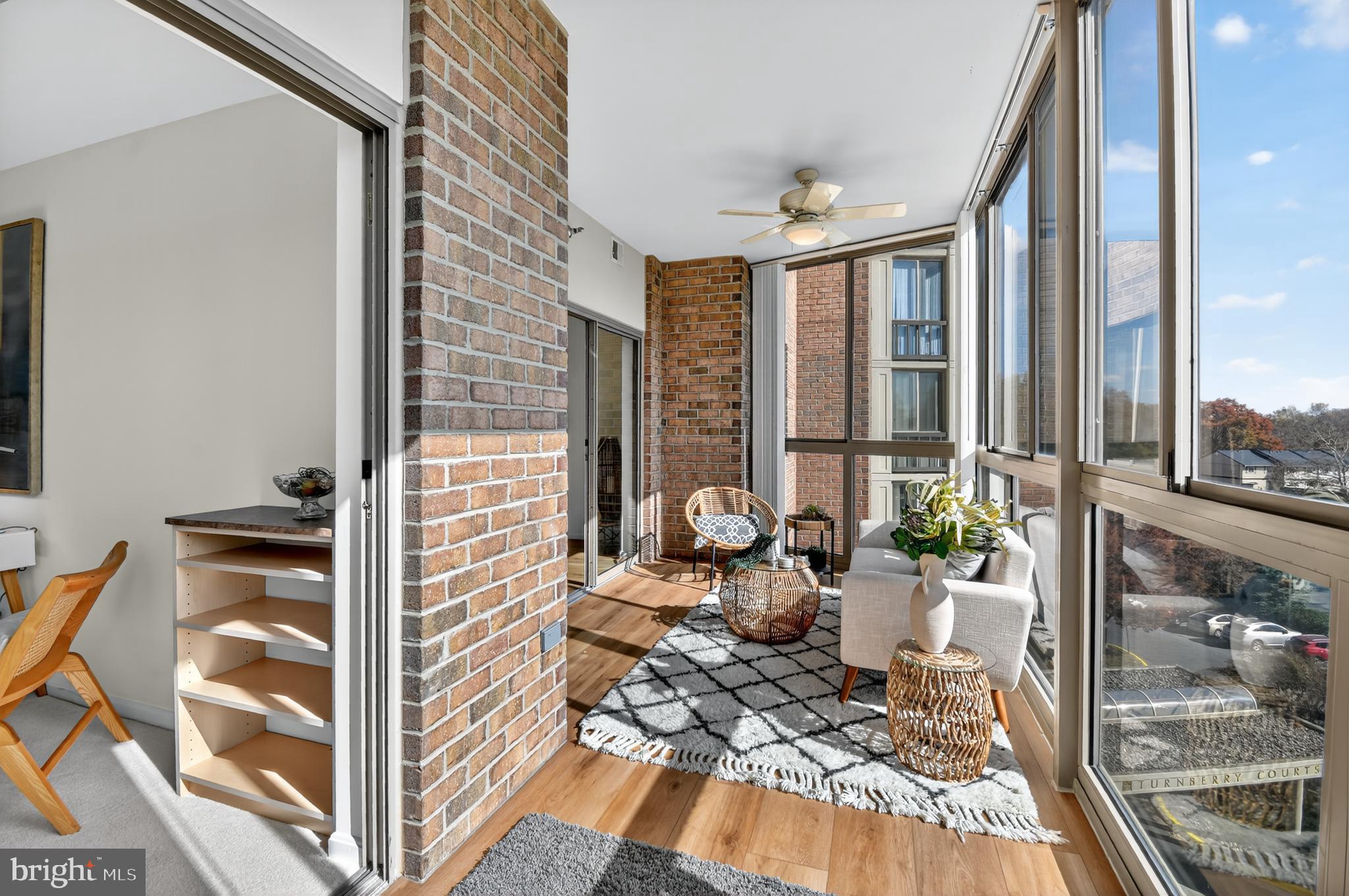 3005 South Leisure World Boulevard, Unit 426 Silver Spring, MD 20906 - Photo 17 of 45 a view of a balcony with chairs and floor to ceiling window