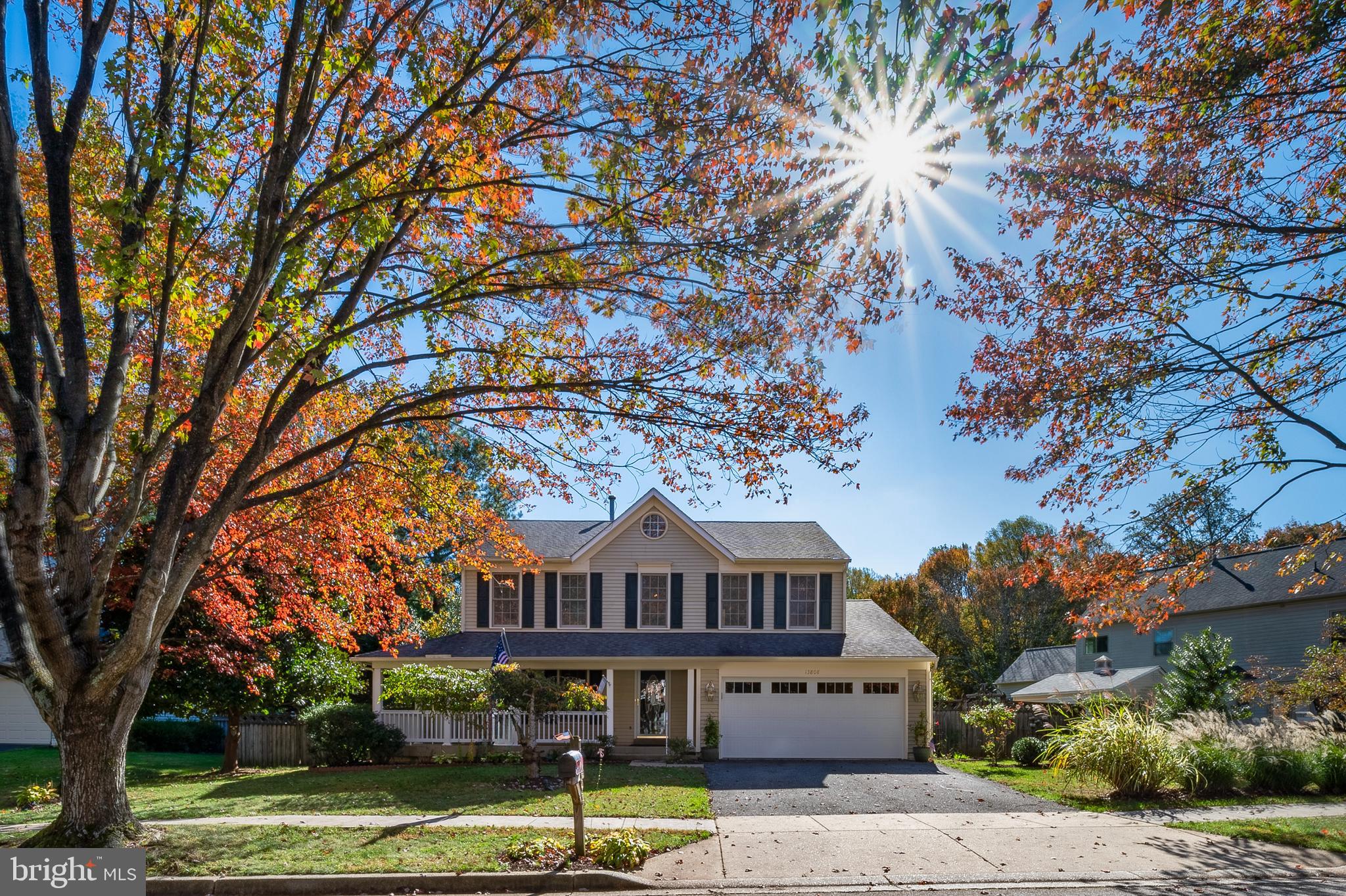 a front view of a house with a yard deck and a tree