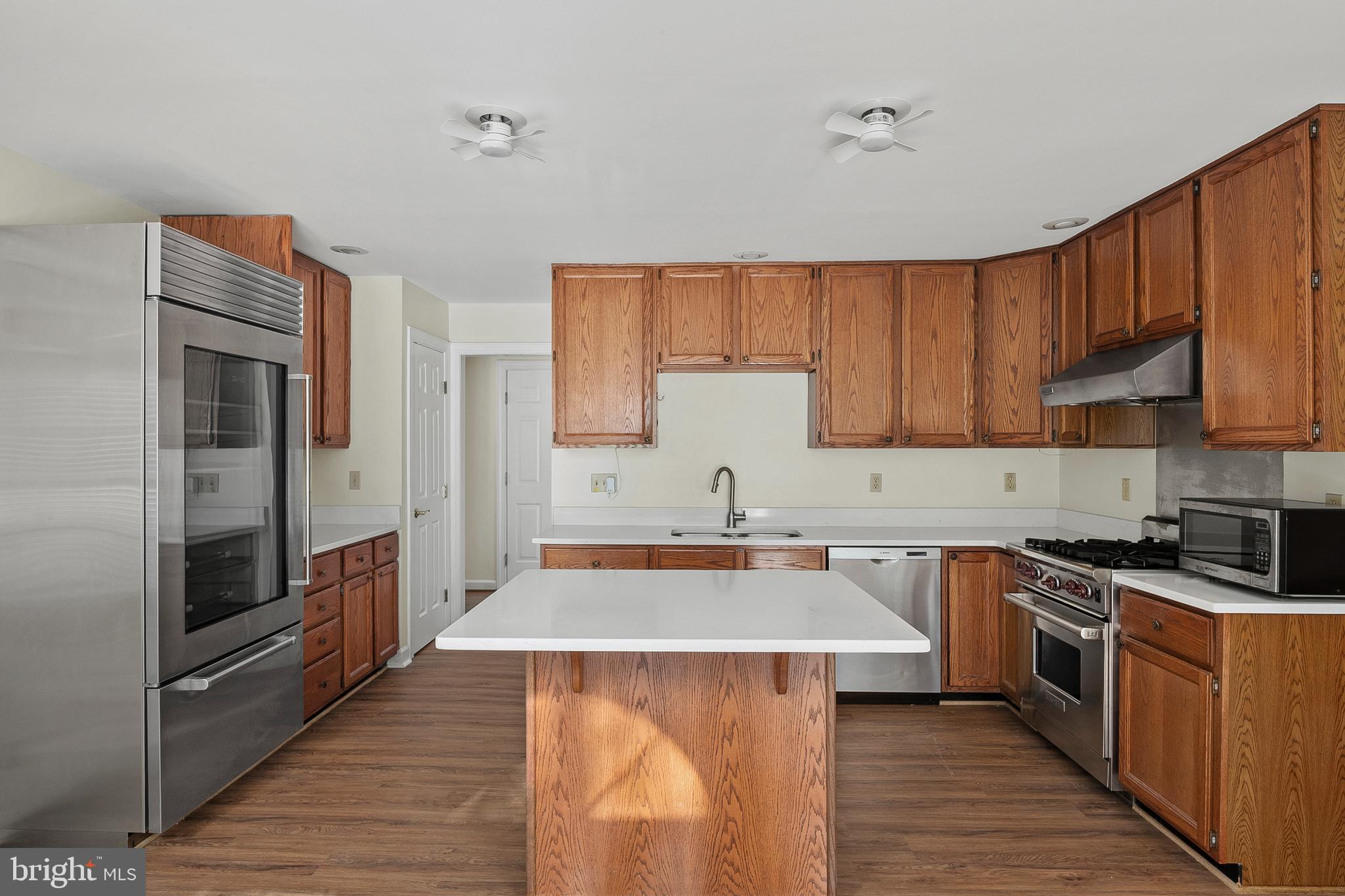 13808 Pleasant View Drive Bowie, MD 20720 - Photo 13 of 46 a kitchen with stainless steel appliances a sink stove refrigerator and cabinets