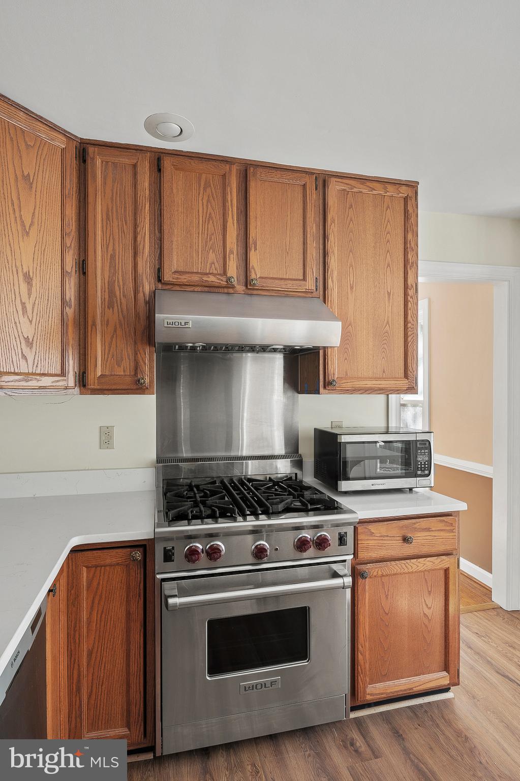 13808 Pleasant View Drive Bowie, MD 20720 - Photo 19 of 46 a kitchen with granite countertop a stove and a sink