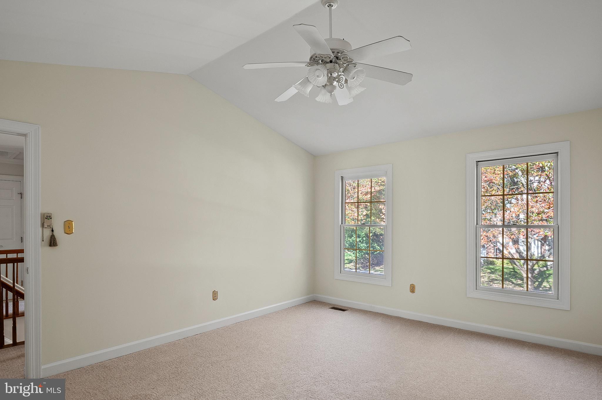 13808 Pleasant View Drive Bowie, MD 20720 - Photo 27 of 46 an empty room with windows and chandelier fan