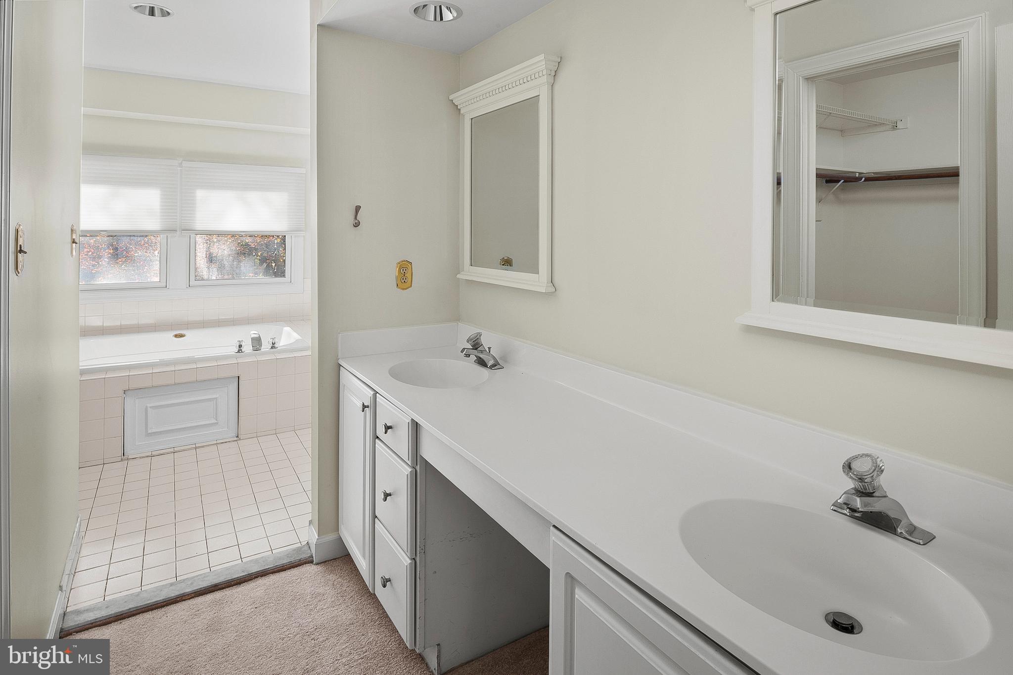 13808 Pleasant View Drive Bowie, MD 20720 - Photo 29 of 46 a spacious bathroom with a sink and a mirror