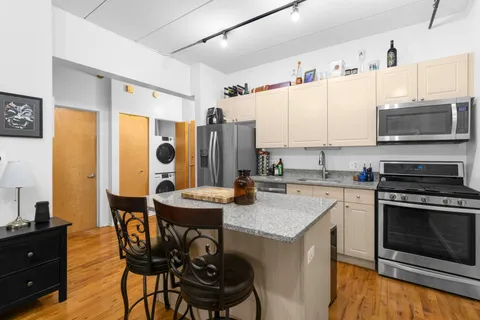 a kitchen with a stove a sink and a refrigerator