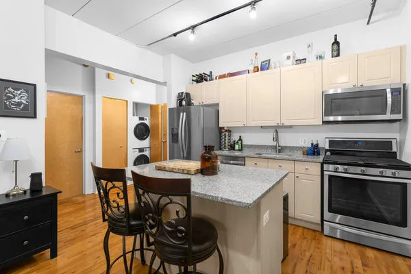 a kitchen with a stove a sink and a refrigerator