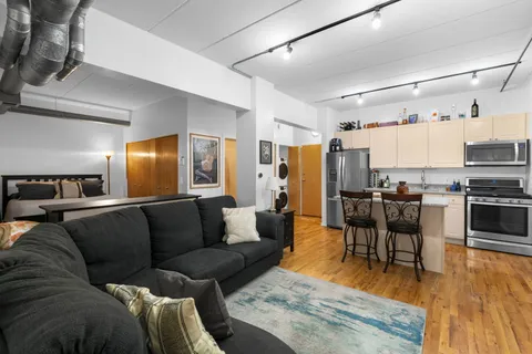 a living room with furniture and kitchen view