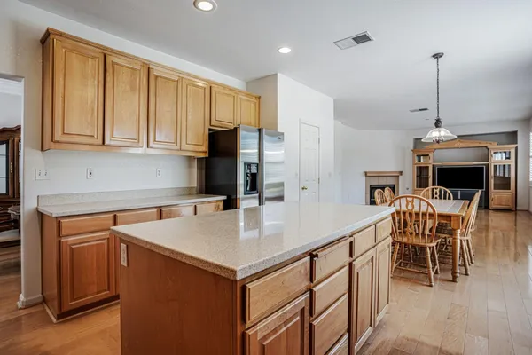 a dining room with furniture a chandelier and wooden floor