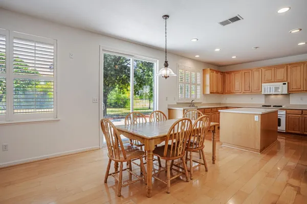 a view of a dining room with furniture wooden floor and chandelier