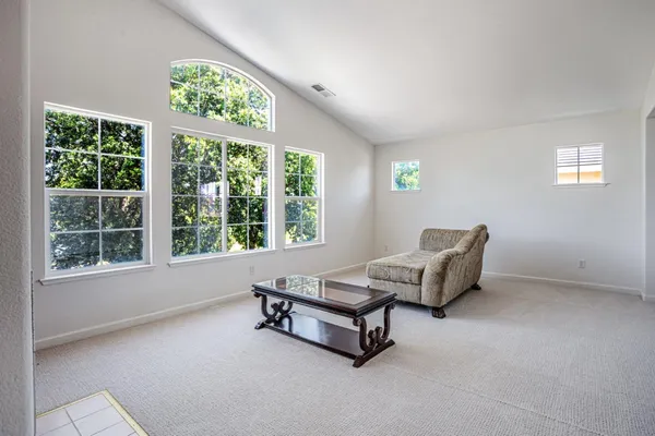 a living room with a bed and a dresser