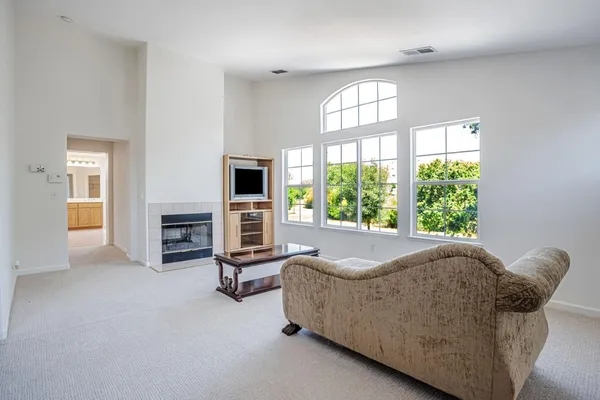 a living room with a couch and a dresser next to a window