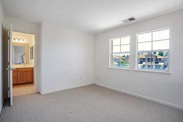 a bathroom with a sink a toilet and a window