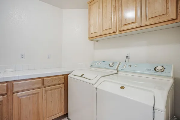 an aerial view of residential houses with outdoor space and trees