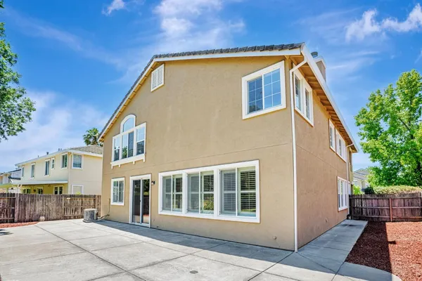 an aerial view of residential houses with outdoor space and trees