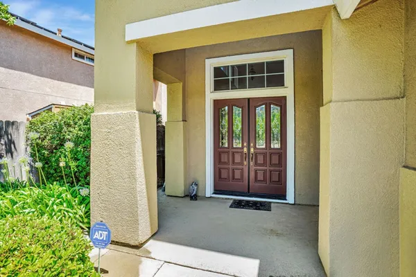 a living room with furniture a table and a chandelier
