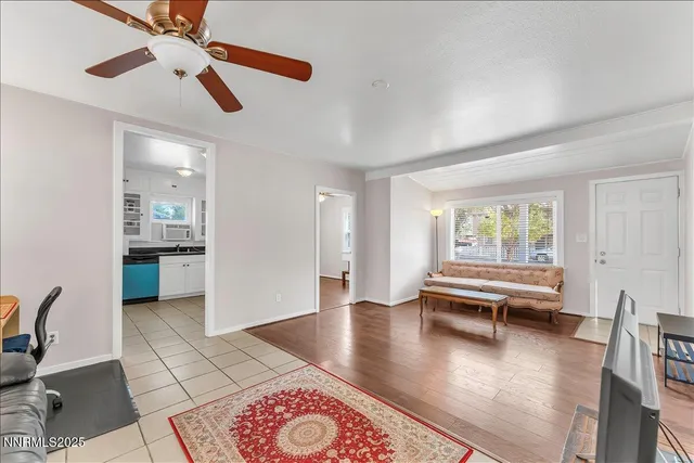 a view of open kitchen with dining table and chairs