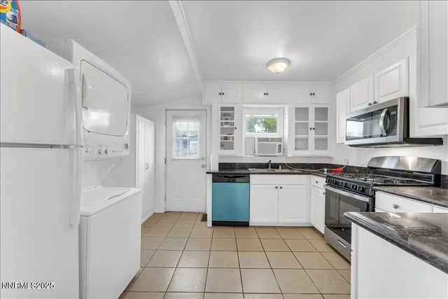 a kitchen with a sink a stove top oven and white stainless steel appliances