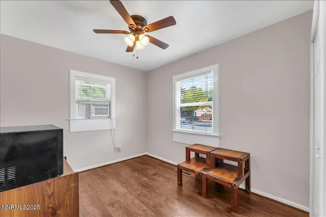 a view of room with window and wooden floor