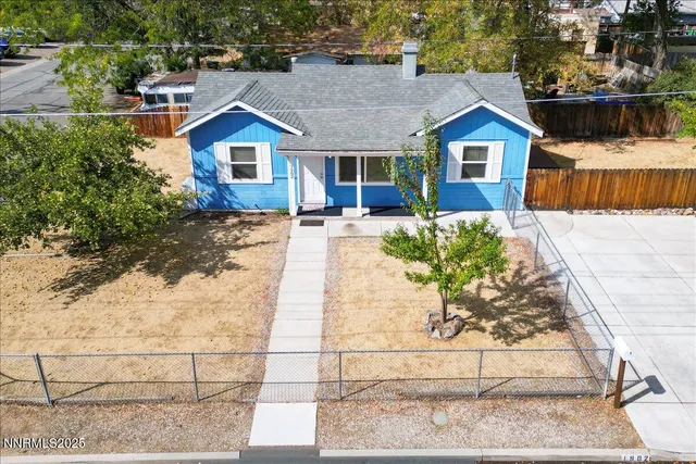a view of a house with a yard and sitting area