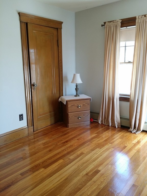 11 Linwood Road Lynn, MA 01905 - Photo 13 of 23 an empty room with wooden floor and a window