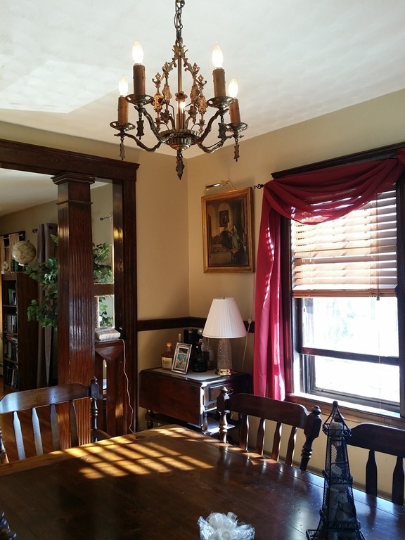 11 Linwood Road Lynn, MA 01905 - Photo 6 of 23 a living room with furniture a dining table and a chandelier