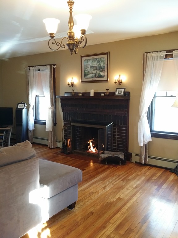 11 Linwood Road Lynn, MA 01905 - Photo 8 of 23 a living room with furniture a fireplace and a chandelier