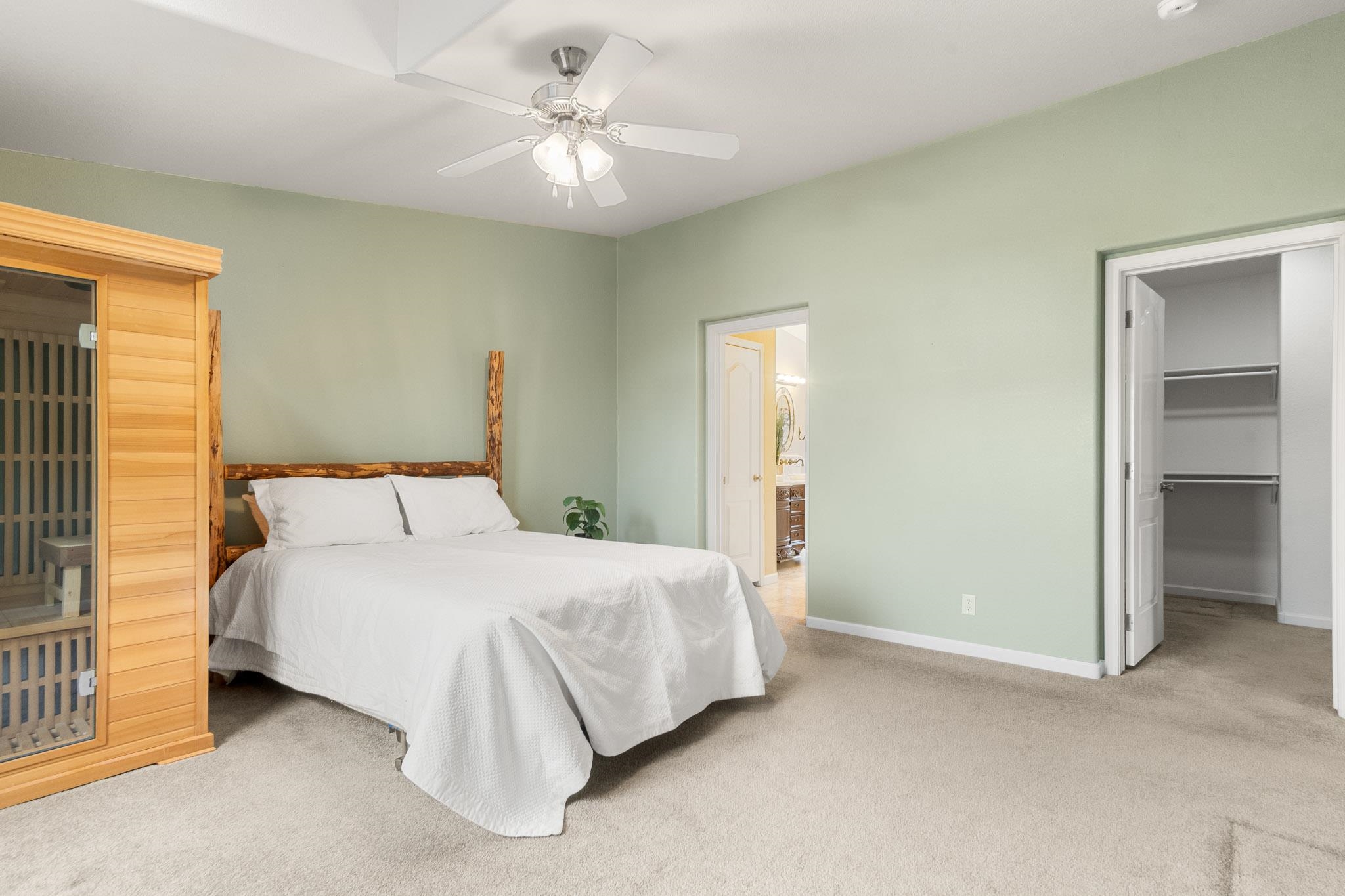 3984 Rapid Creek Road Palisade, CO 81526 - Photo 19 of 30 a bedroom with a bed and a chandelier