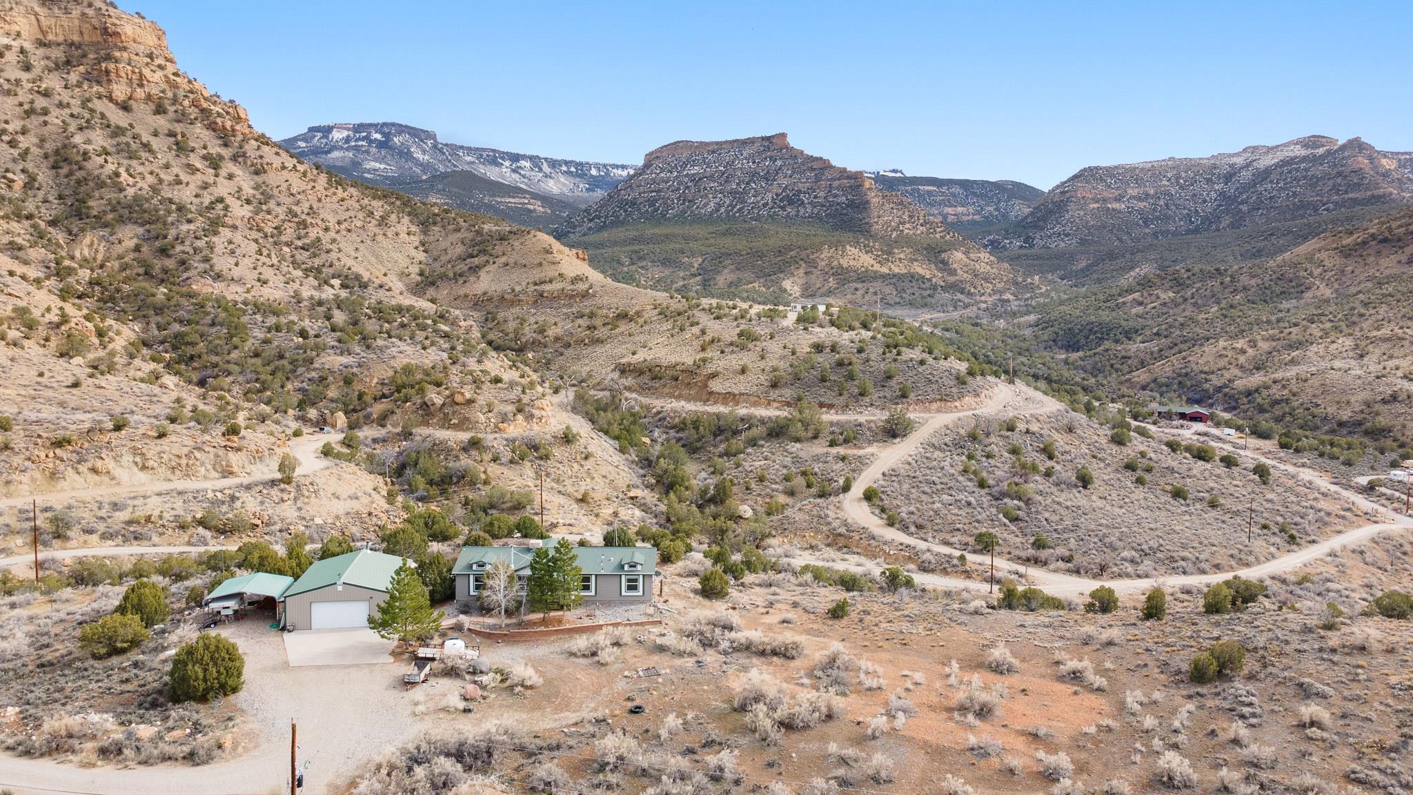 3984 Rapid Creek Road Palisade, CO 81526 - Photo 5 of 30 a view of a dry field with mountains in the background