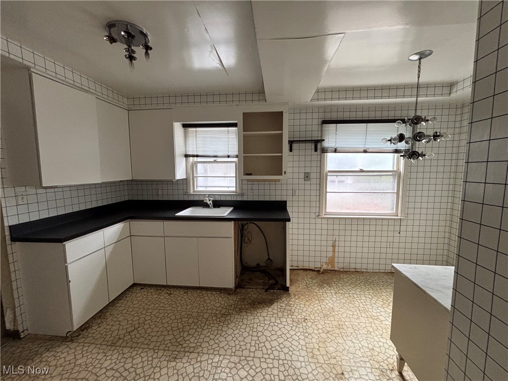4308 Silsby Road University Heights, OH 44118 - Photo 3 of 28 Kitchen with white cabinetry, tile walls, and sink