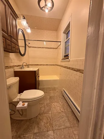 a bathroom with a toilet a sink and a mirror