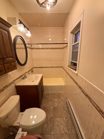 a bathroom with a sink mirror vanity and toilet