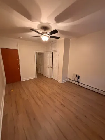 a view of room with wooden floor