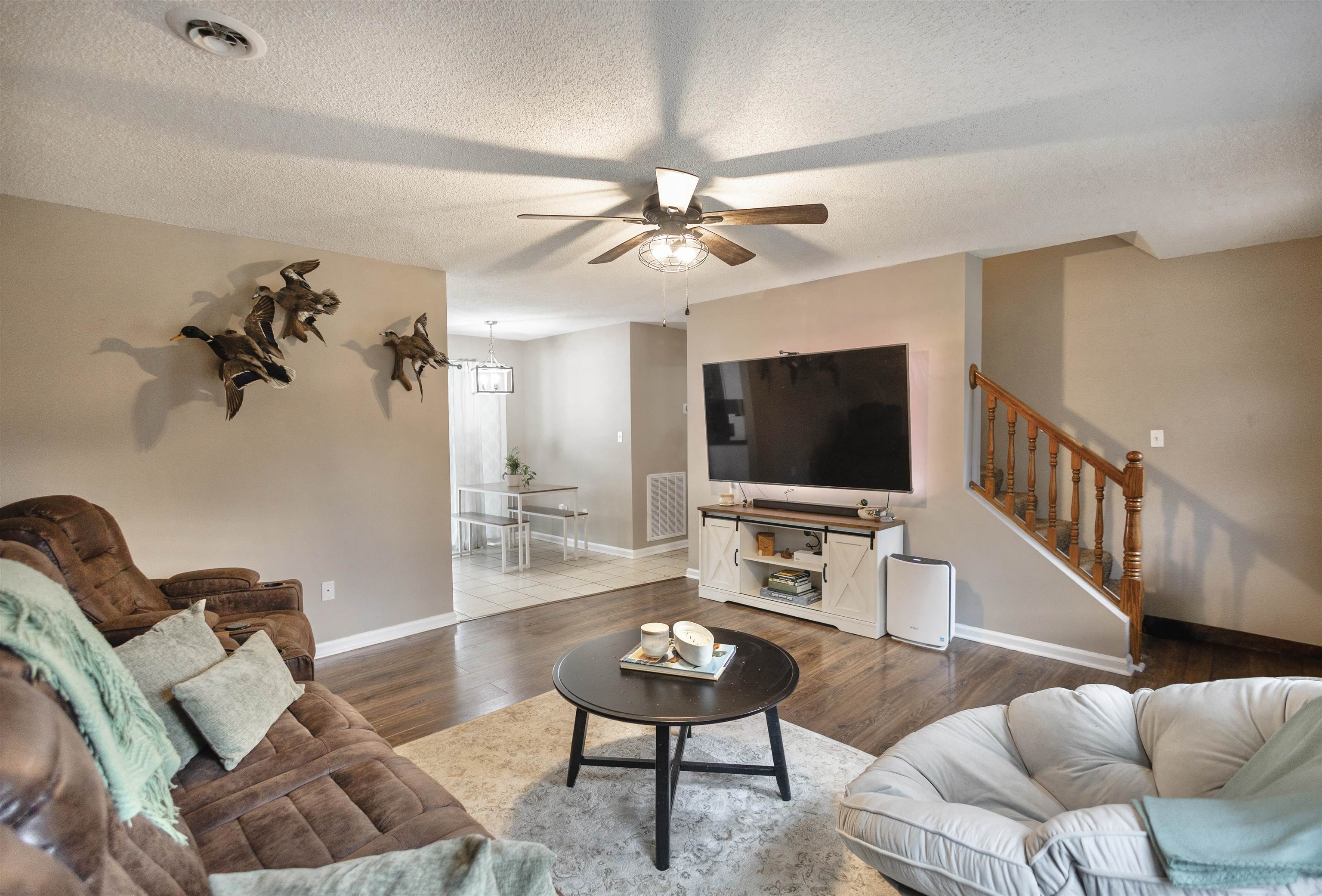 9664 Holly Grove Road Brighton, TN 38011 - Photo 3 of 21 Living room featuring ceiling fan, hardwood / wood-style floors, and a textured ceiling