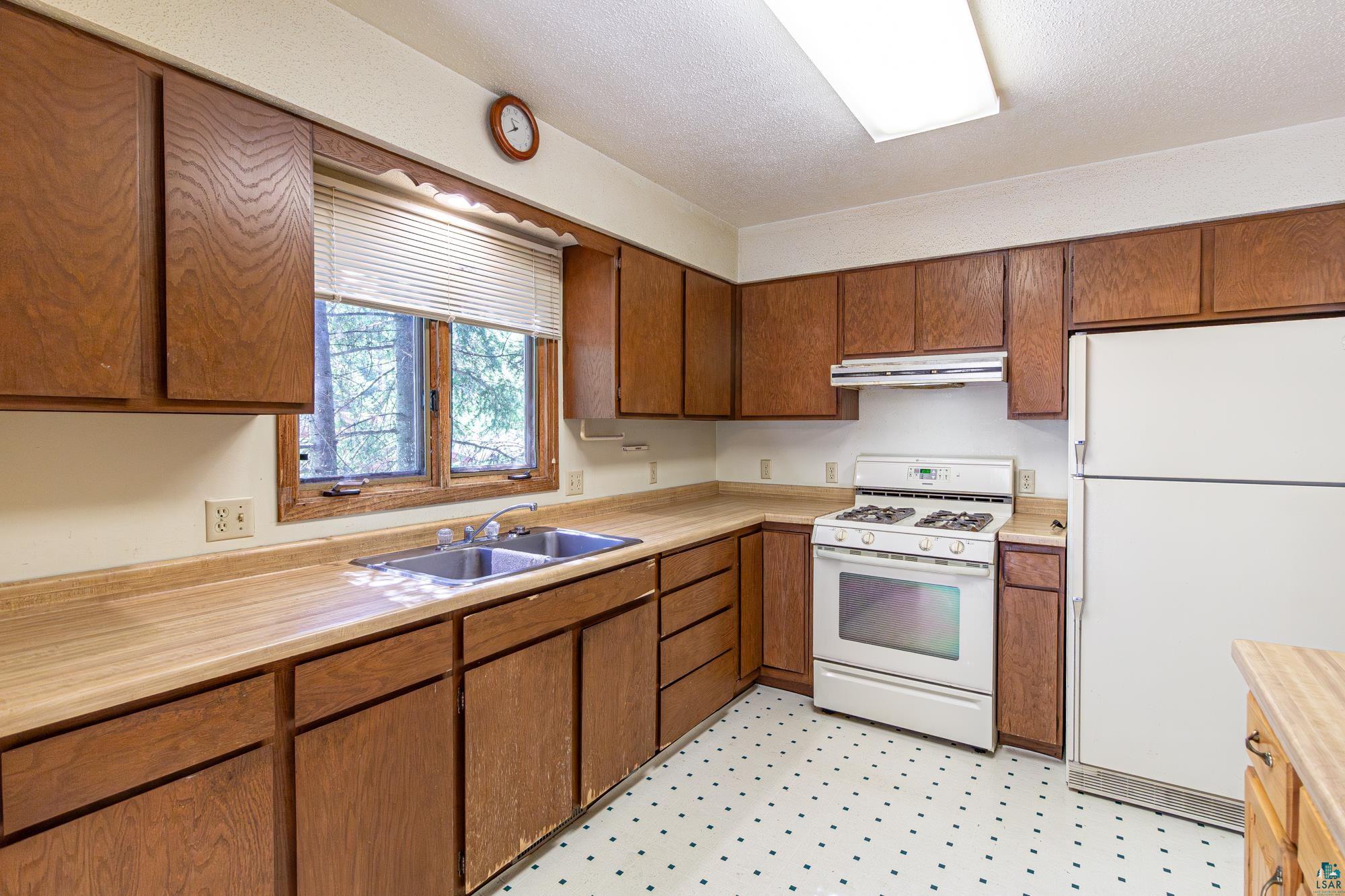 14687 North Country Road Ely, MN 55731 - Photo 4 of 44 Kitchen with sink, white appliances, and light tile floors