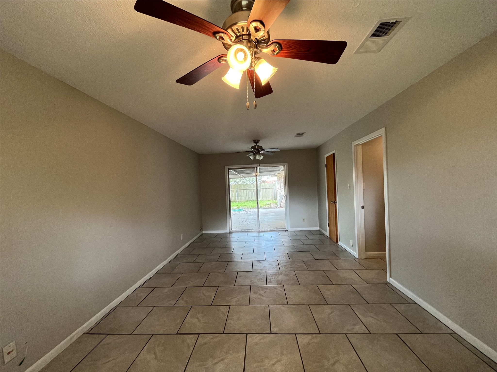 3924 Wickersham Street Bay City, TX 77414 - Photo 17 of 20 a view of a livingroom with a chandelier fan and windows