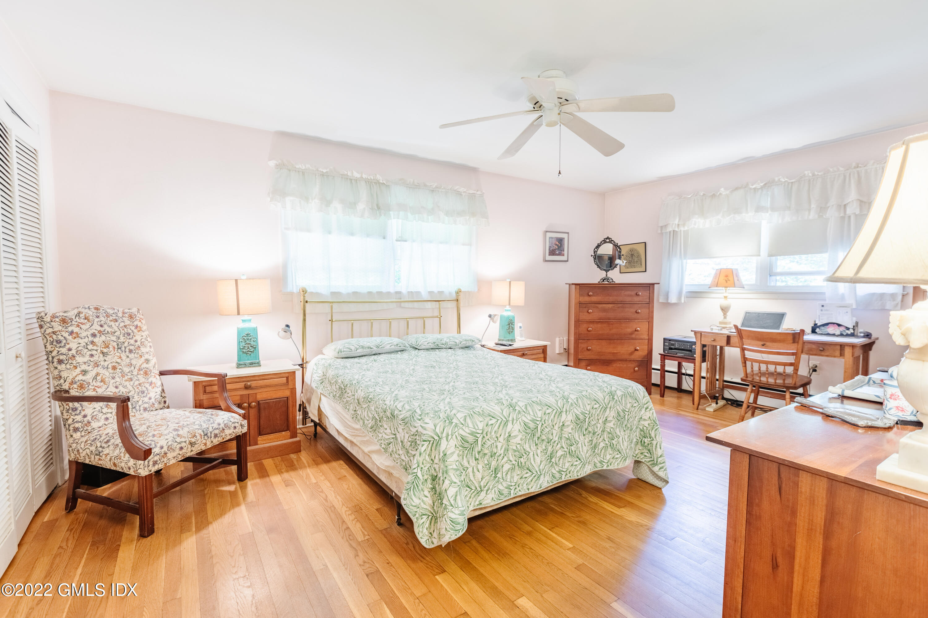 65 Laddins Rock Road Old Greenwich, CT 06870 - Photo 16 of 40 a bedroom with a bed and wooden floor