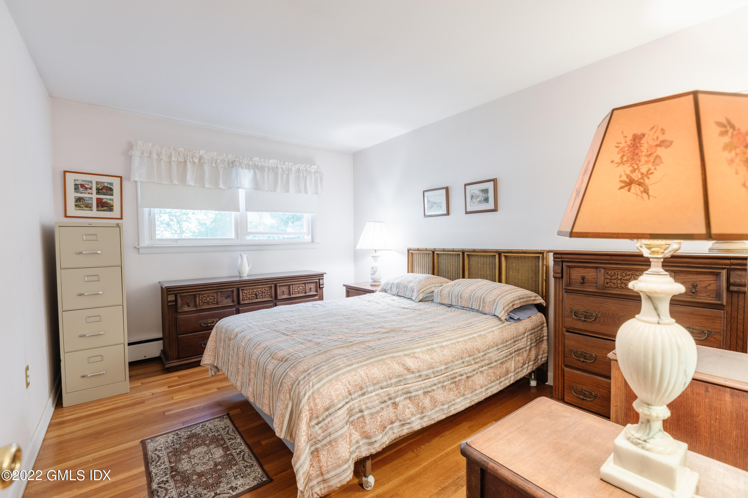 65 Laddins Rock Road Old Greenwich, CT 06870 - Photo 19 of 40 a bedroom with a bed and a couch