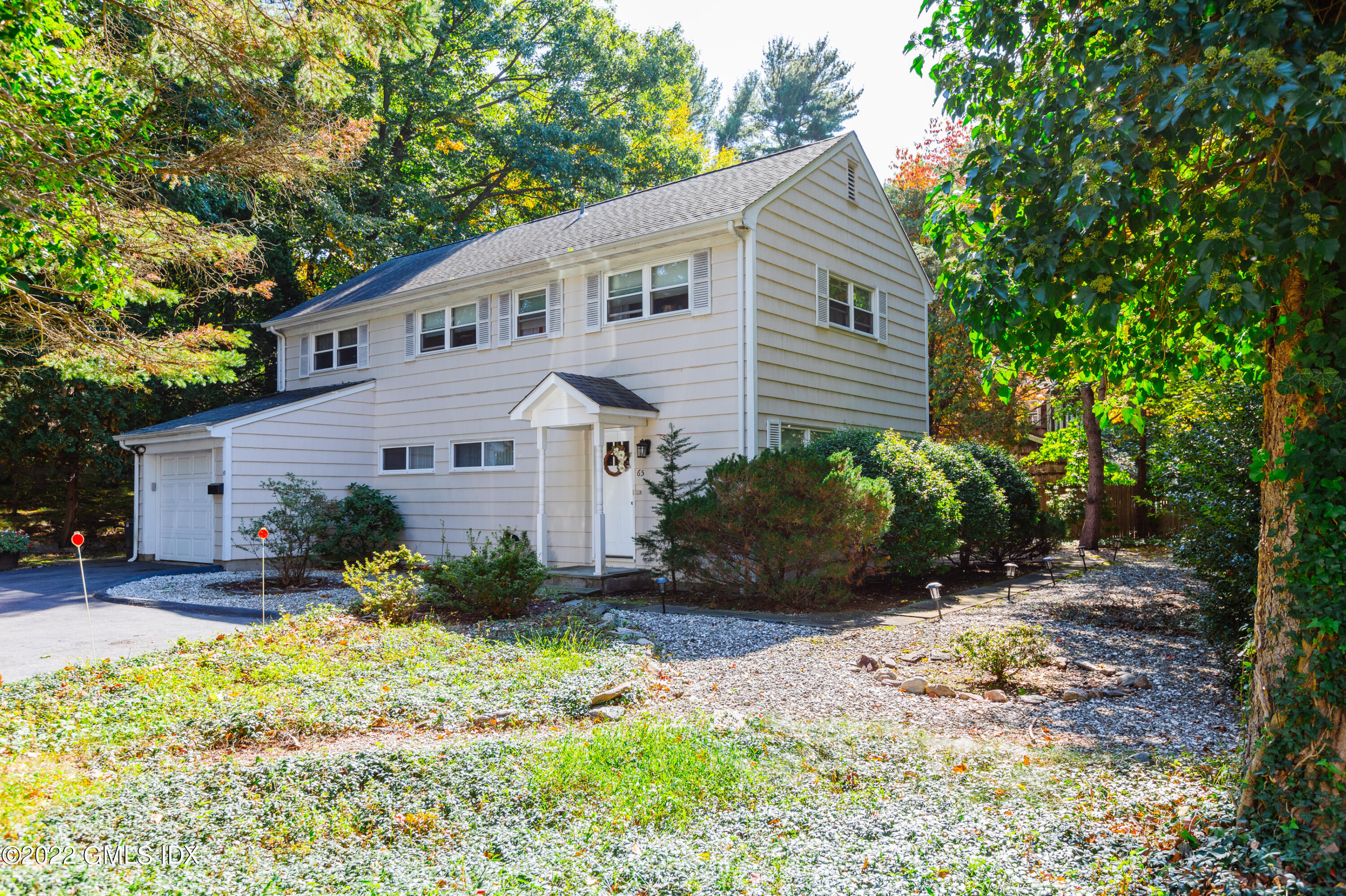 65 Laddins Rock Road Old Greenwich, CT 06870 - Photo 2 of 40 a view of a house with yard and plants